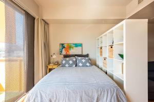a bedroom with a bed and a large window at Studio nr Town Lake and E6th w Balcony by Austin Vacay in Austin