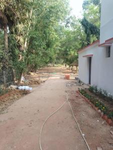 a driveway with a hose on the ground next to a building at CHAYAA BITHII Resort & Restaurant in Kopāi