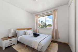 a bedroom with a bed with a teddy bear on it at Comfortable Home for 6 - Canberra Inner North in Belconnen