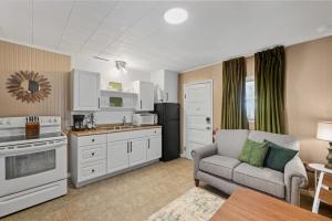 a living room with a couch and a kitchen at A Cedar Key Dock Holiday! in Cedar Key