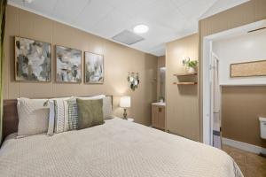 a bedroom with a bed and a bathroom at A Cedar Key Dock Holiday! in Cedar Key