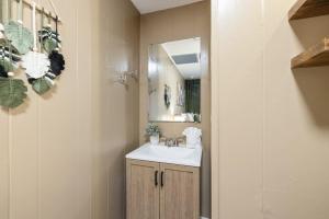 a bathroom with a sink and a mirror at A Cedar Key Dock Holiday! in Cedar Key +18 photos