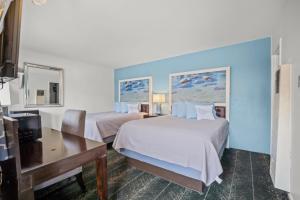 a hotel room with two beds and a desk at Bluebird Day Inn & Suites in South Lake Tahoe +20 photos