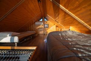 a room with two beds in a wooden cabin at Danube Retreat in Belgrade