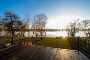 a wooden deck with a view of a body of water at Danube Retreat in Belgrade +22 photos