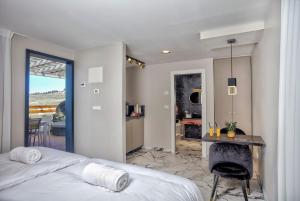a bedroom with a bed and a table and a kitchen at Yourest HaAri - יורסט הארי in Safed