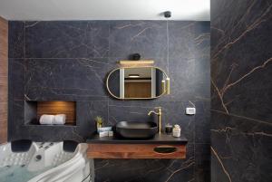 a bathroom with a sink and a mirror at Yourest HaAri - יורסט הארי in Safed