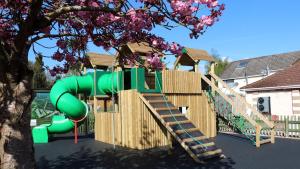 a playground with a green slide and a staircase at 1. Forest Edge 2 Bedroom Statement Caravan in Saint Leonards +2 photos