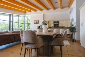 a kitchen and living room with a wooden ceiling at Sheelin Lake House in Cavan