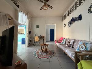 a living room with a couch and a table at KazParadis les Saintes in Terre-de-Haut