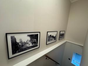 a stairway with three pictures on the wall at Half Moon Nest - Refurbished throughout for 2026 in Diss