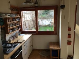 a kitchen with a window and a counter top at Maison Nancy Thermal in Nancy