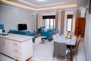 a living room with a couch and a table at Kigali Great Garden in Kigali