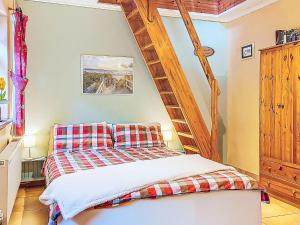a bedroom with a bed and a wooden ladder at Studio Eagle Nest by Interhome in Lettermacaward +24 photos