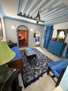 a living room with a couch and a table and a mirror at Dar kenza Tunis in Tunis
