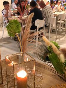a candle on a table with people sitting at tables at Hotel Rio Bellaria in Bellaria-Igea Marina +92 photos