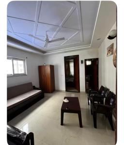 a living room with a couch and a table at E block in Rājpur