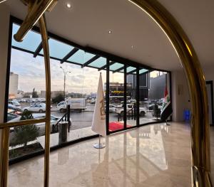 a large window in a building with a view of a parking lot at Abraj Al Madina Hotel in Al Fayşalīyah