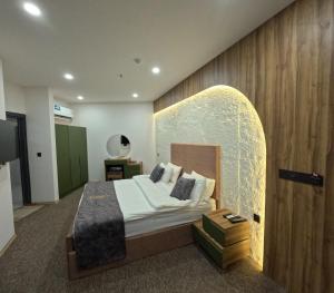 a hotel room with a bed with a surfboard on the wall at Abraj Al Madina Hotel in Al Fayşalīyah +81 photos