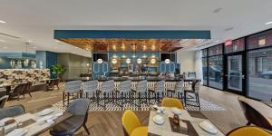 a restaurant with tables and chairs and a bar at Hotel Indigo New Orleans - French Quarter by IHG in New Orleans