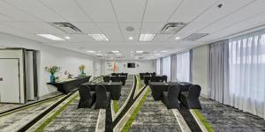a conference room with black chairs and a podium at Hotel Indigo New Orleans - French Quarter by IHG in New Orleans