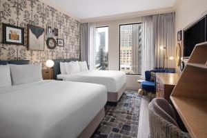 a hotel room with two beds and a window at Hotel Indigo New Orleans - French Quarter by IHG in New Orleans +133 photos