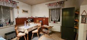 a kitchen with a table and a refrigerator at Ferienwohnung am Wald in Tharandt