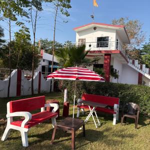 a group of chairs and an umbrella in front of a house at The ROYAL OASIS in Khetri