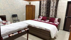 a bedroom with a large bed with purple pillows at The ROYAL OASIS in Khetri
