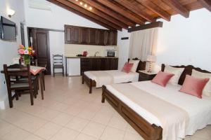 a large room with two beds and a kitchen at Afrodite Hotel Apartments in Myrina +44 photos