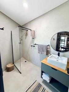 a bathroom with a sink and a shower at Mizpah Lodge in Bloemfontein +55 photos
