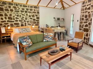a bedroom with a bed and a living room at Mizpah Lodge in Bloemfontein