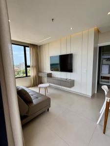 a living room with a couch and a flat screen tv at Milord Suites & Apartments in Encarnación