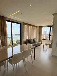 a living room with a couch and a table and chairs at Milord Suites & Apartments in Encarnación