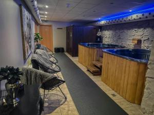 a bar in a room with a large tub at Hotel Vestmannaeyjar in Vestmannaeyjar +84 photos