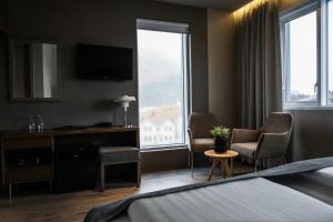 a hotel room with a bed and a window at Hotel Vestmannaeyjar in Vestmannaeyjar