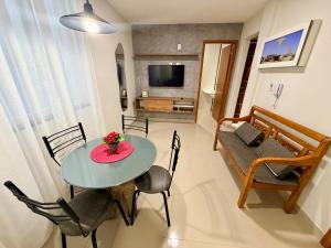 a living room with a table and a couch at Elohim Residencial in Rio de Janeiro