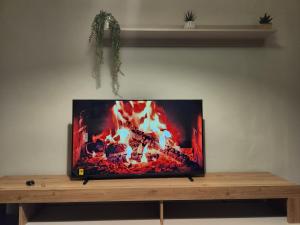 a flat screen tv sitting on top of a wooden table at Casa di ringhiera 1 in Pinerolo
