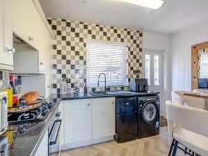 a kitchen with a sink and a dishwasher at Sunrise Cottage in Berwick-Upon-Tweed