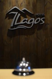 a close up of a hotel zeus sign and a bell at Hotel 7 Lagos in San Carlos de Bariloche