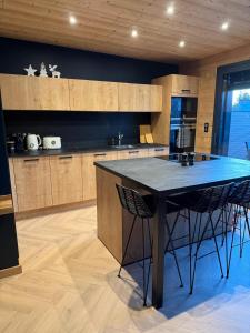 a kitchen with a table and two chairs in it at Le Petit Nid D'Amour in Évans +8 photos