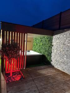 a pavilion with a tree and a bath tub at Le Petit Nid D'Amour in Évans