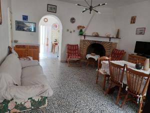 a living room with a couch and a table and a fireplace at Villetta Frasena in Santa Maria