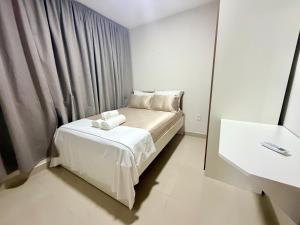 a small bedroom with a bed and a mirror at Elohim Residencial in Rio de Janeiro