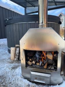 an outdoor grill with a fire in it at ODSKOCZNIA Rewa in Rewa