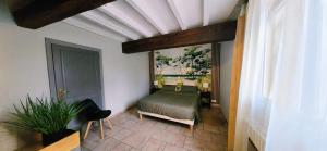 a bedroom with a bed in a room at La Cour d'Arblade in Arblade-le-Haut