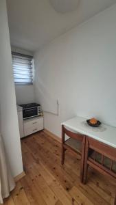 a small kitchen with a table and a stove at Studio VA2016 in Kruševac