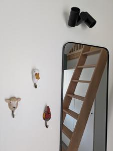 a ladder next to a mirror on a wall at Au Bois Chantant in Somme-Leuze +56 photos