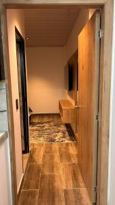 a hallway of a room with wooden floors and a television at aparta hotel del toro in Estación El Salto +2 photos