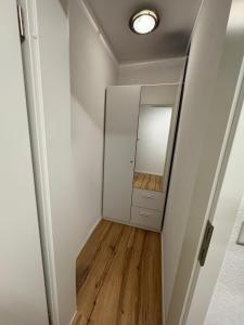 a hallway with a mirror and a white wall at Apartment TraumSeeblick Immenstaad in Immenstaad am Bodensee